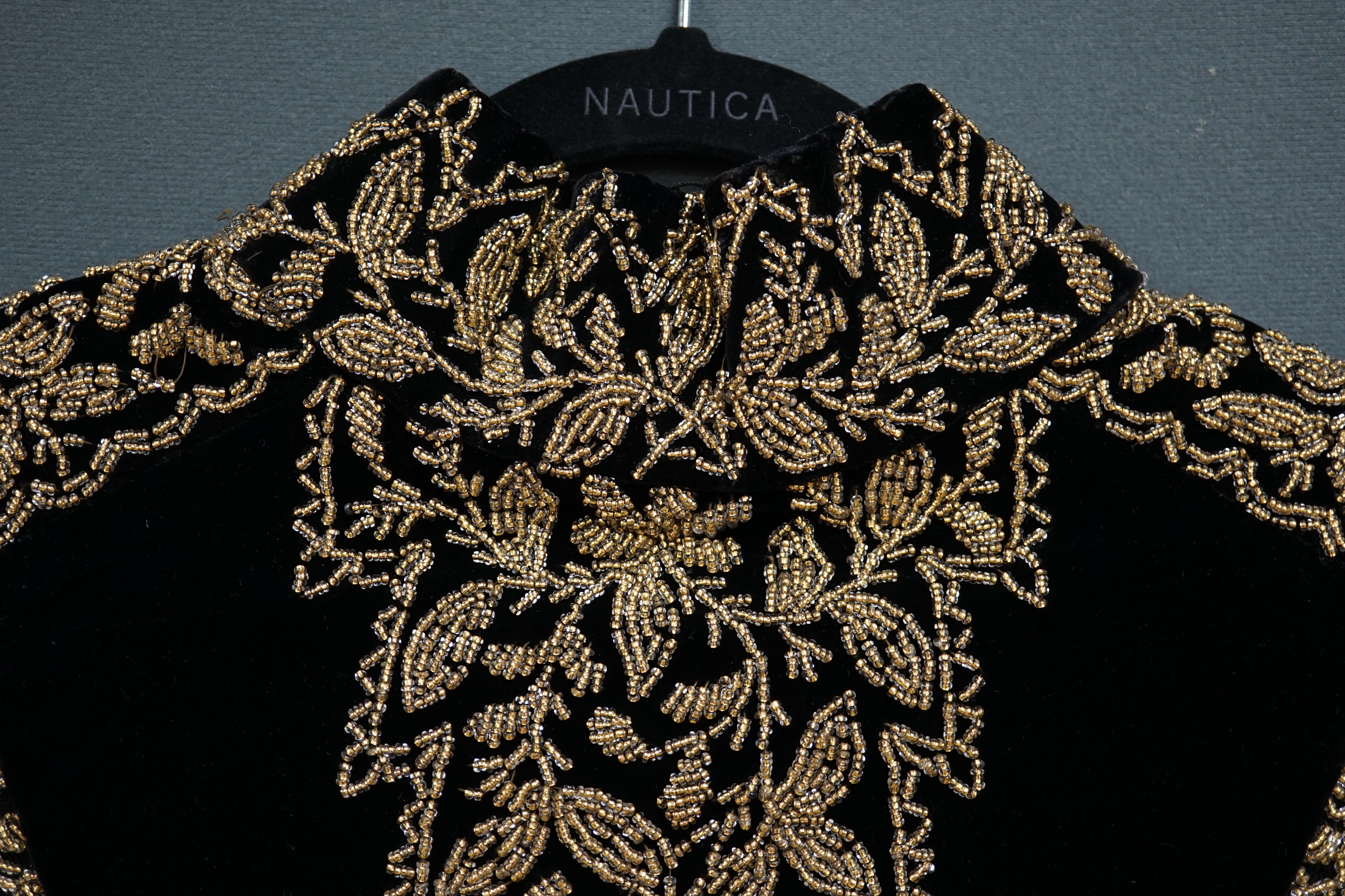 An Edwardian French black velvet and elaborately beaded evening over collar, with makers label, ‘Fillet’, designed with a high collar, front and back panels, all heavily bead worked in an intricate floral design, attache